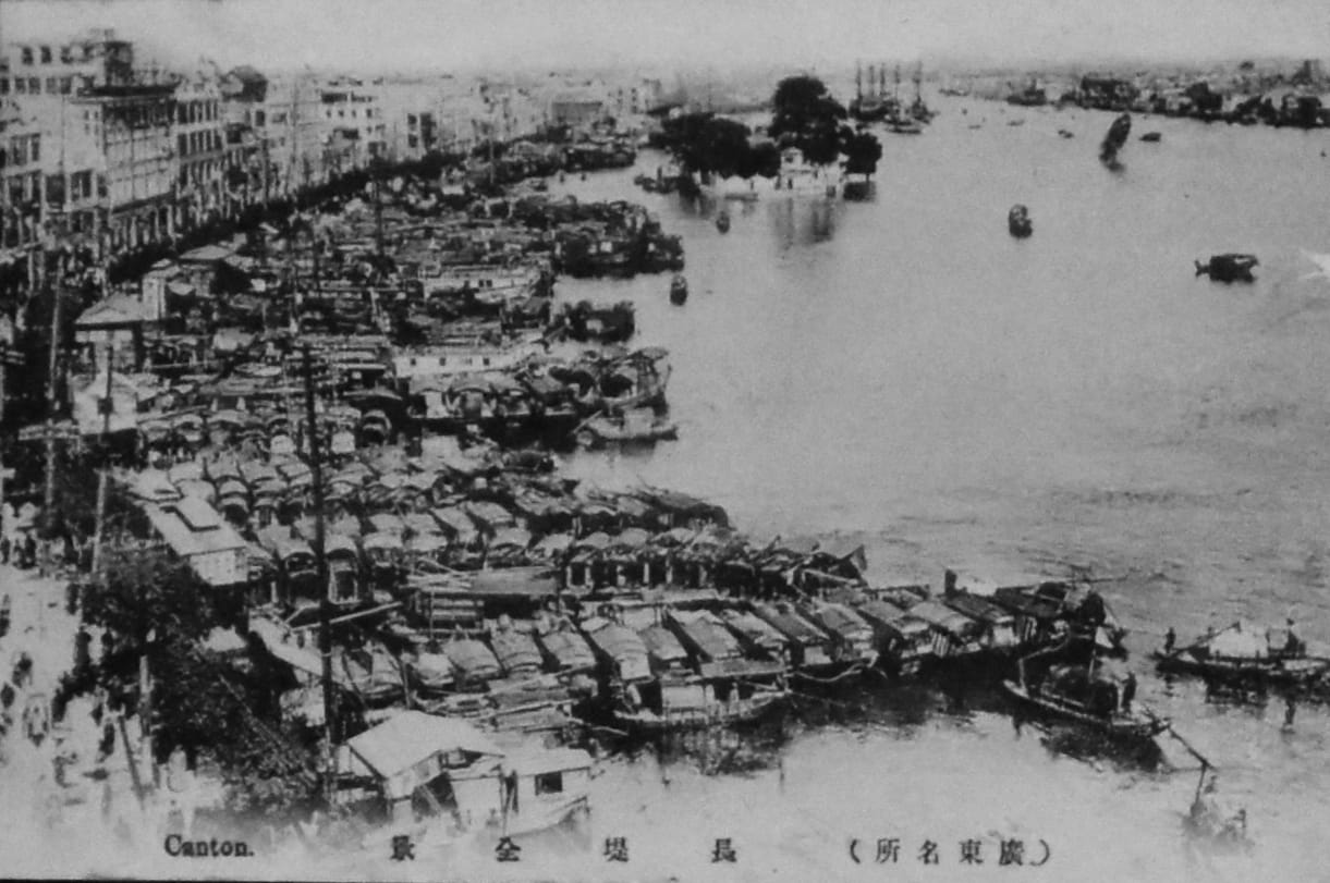 Wooden fishing boats are densely packing into a small port on the Pearl River