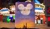 a photo of a book in front of midway lights